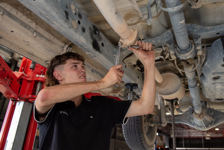 Elite Tune mechanic doing a 4x4 exhaust upgrade